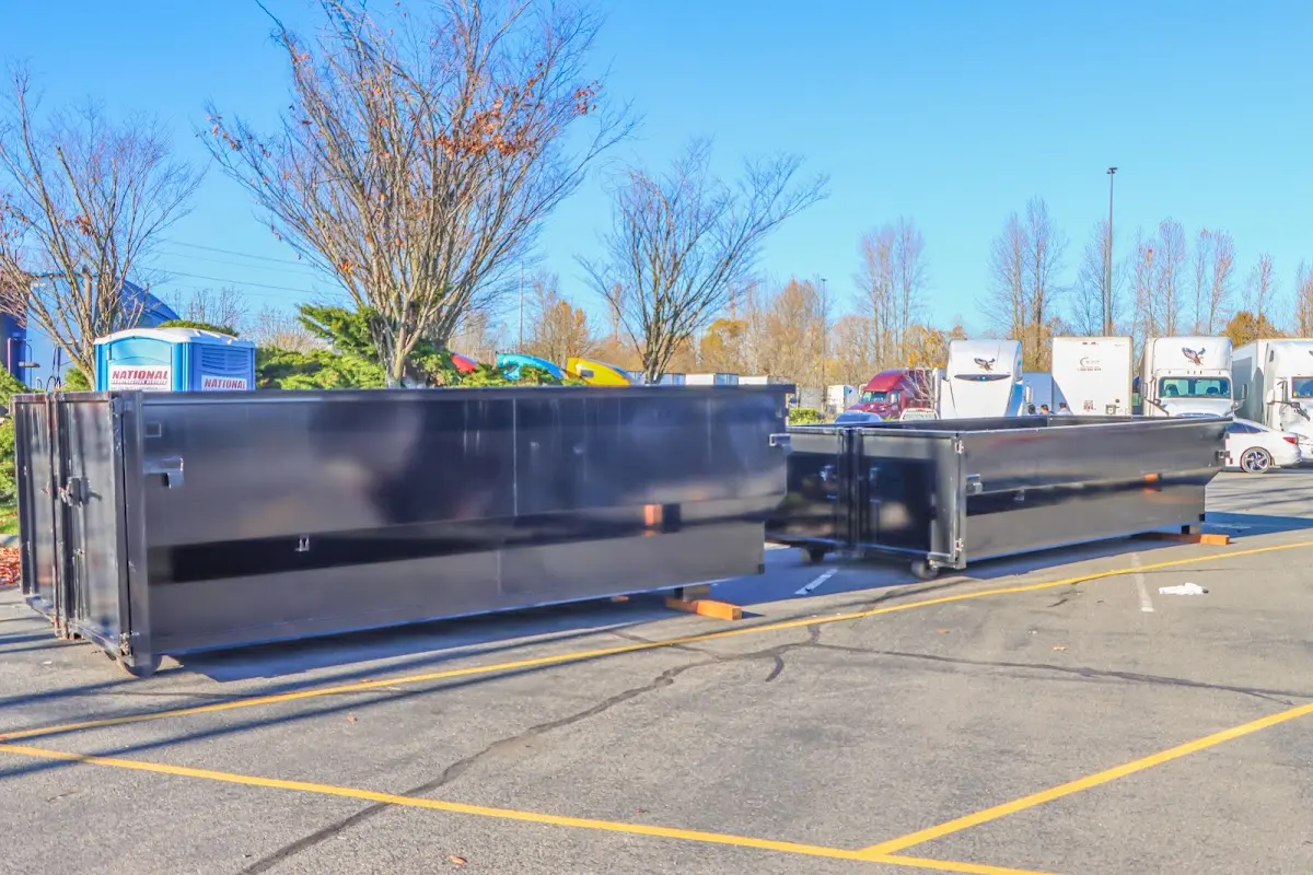 Professional dumpster rental service with roll-off container on residential driveway in Rockmart